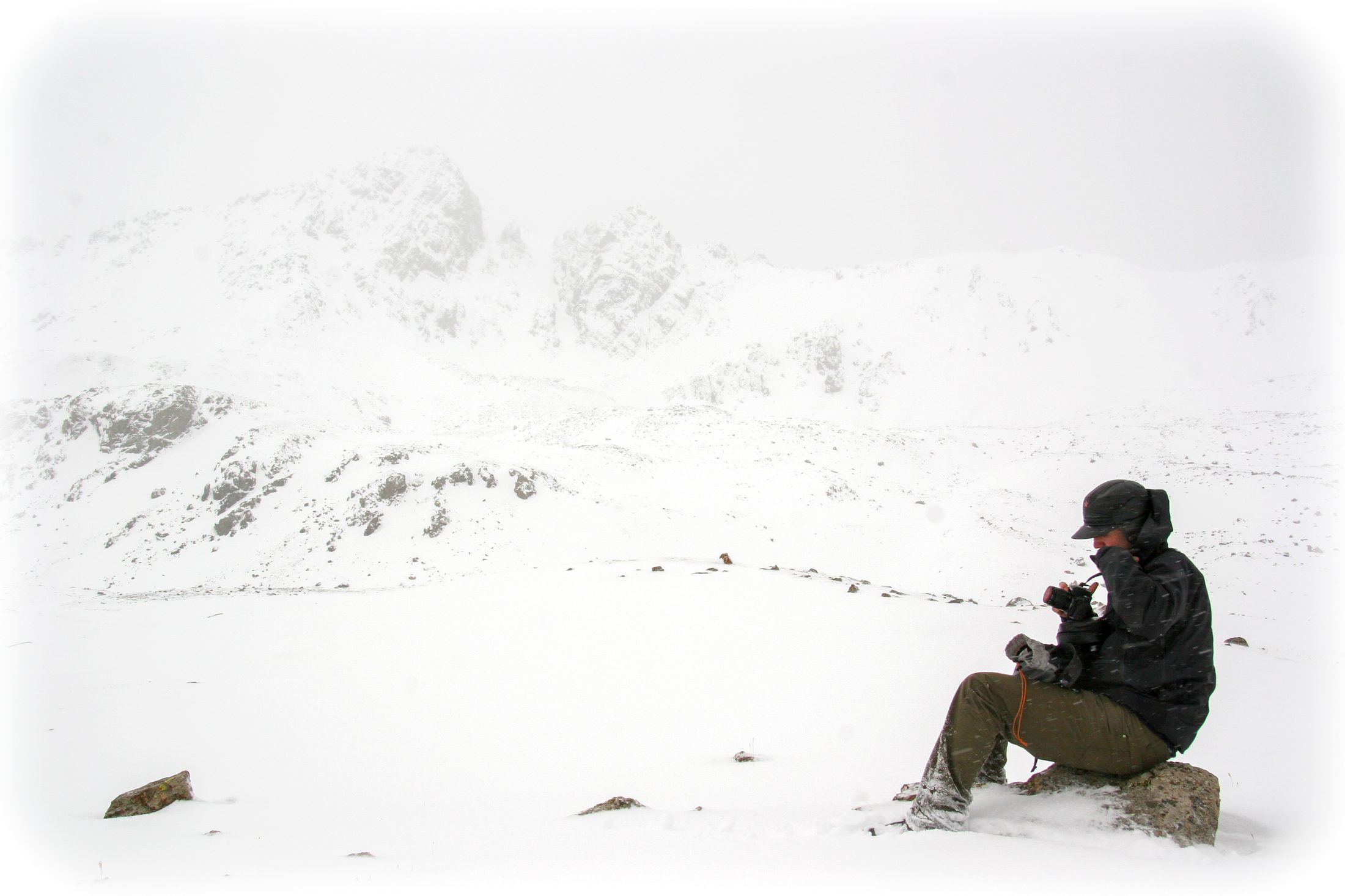 JP Coakley photographing in a snowstorm in the mountains